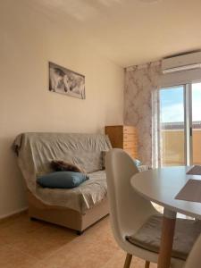 a living room with a couch and a table at Уютные апартаменты с боковым видом на море in Torrevieja