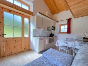 a kitchen with a table and a dining room at Chalet I Clus in Livigno