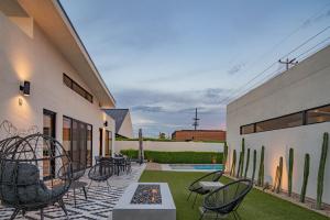 a patio with chairs and tables and a fence at Casa Danesa - Pool - Golf - Luxe & Modern in Phoenix