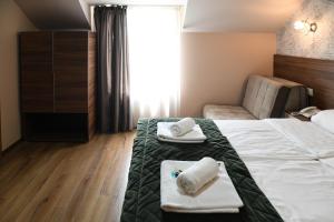Postel nebo postele na pokoji v ubytování Hotel Garden