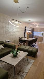 a living room with a couch and a table at Capsula Luxury Apartment Umag in Umag