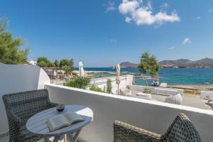 a table and chairs on a balcony overlooking the ocean at ILIAS SEA VIEW in Pollonia
