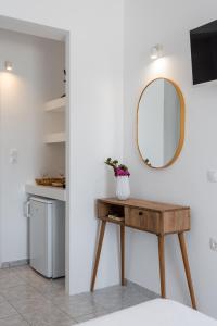 a bathroom with a wooden table and a mirror at ILIAS SEA VIEW in Pollonia