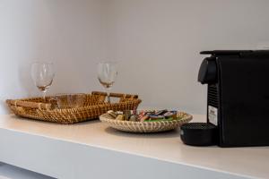 two baskets and wine glasses on a counter next to a microwave at ILIAS SEA VIEW in Pollonia