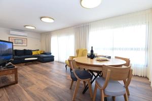 a living room with a table and a couch at נוף העמק - דירה מהממת עם נוף עוצר נשימה in Nof Kinneret