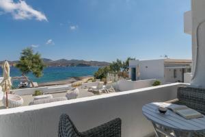 a balcony with a table and chairs and the water at ILIAS SEA VIEW in Pollonia +7 photos