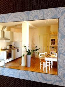 a kitchen and dining room with a table and chairs at B&B Day by day in Iseo