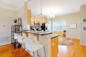 a kitchen with white chairs and a counter top at Rehoboth Crossing --- 19913 Ames Drive #106 in Rehoboth Beach