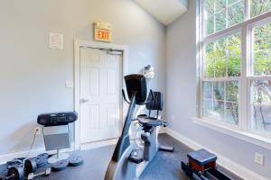 a room with a gym with a treadmill and an exit sign at Rehoboth Crossing --- 19913 Ames Drive #106 in Rehoboth Beach