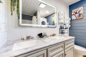a bathroom with a white sink and a mirror at The Montclair Drive Delight in Kalispell +38 photos