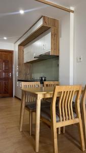 a wooden table and chairs in a kitchen at KIM HOUSE in Danang