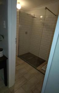 a shower with a glass door in a bathroom at Yalta Park in Pietermaritzburg