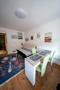 a room with a bed and a table and chairs at Apartman Daris in Sarajevo