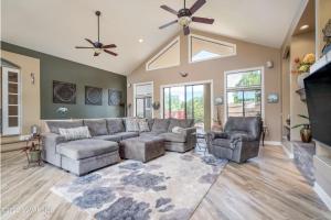 a living room with a couch and chairs and a ceiling fan at Large Sedona Property with Private Pool! 7 Bedrooms! in Sedona
