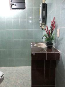 a bathroom with a sink and a phone on the wall at lindo departamento independiente in Taxco de Alarcón