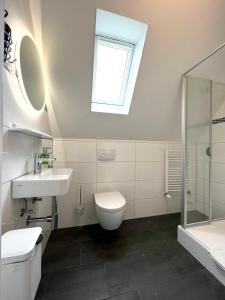 a bathroom with a sink toilet and a window at Pension Seepferdchen in Norddeich