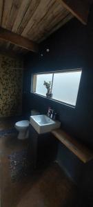 a bathroom with a sink and a toilet at Hartbeest Eco Bush Lodge 3 in Hartbeespoort