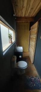 a bathroom with a toilet and a sink at Hartbeest Eco Bush Lodge 3 in Hartbeespoort