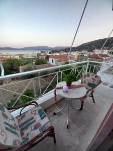 a balcony with two chairs and a table and a view at Panorama in Methana