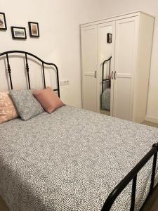 a bedroom with a bed with a black frame at Malvarrosa Private Rooms in Shared Apartment in Valencia