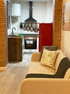 a living room with a couch in a kitchen at Malvarrosa Private Rooms in Shared Apartment in Valencia