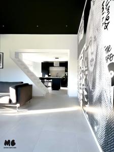 a room with a staircase and a wall with writing on it at Maison Brigitte - Jacuzzi Videoprojecteur Xbox in Aulnoy