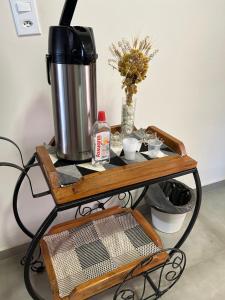 a wooden cart with a coffee maker on it at Pousada Serra Branca in São Thomé das Letras