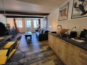 a living room with a couch and a table at La Perle du Port in Vannes