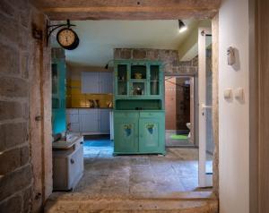 a kitchen with a green cabinet in a room at Manor house Aman in Komiža