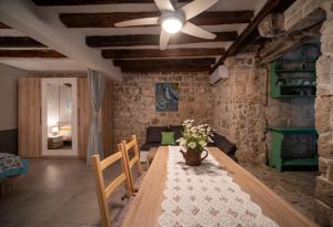 a dining room with a wooden table and chairs at Manor house Aman in Komiža