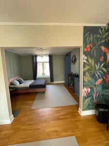 una sala de estar con una cama y una pintura en la pared en Villa Artiz, en Dunkerque
