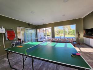 a living room with a ping pong table at Casa en Club de Campo. Parque y Pileta. in San Nicolás de los Arroyos