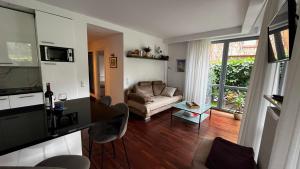 a living room with a couch and a table at Apartament Willa Woda in Jurata