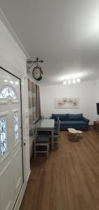 a living room with a blue couch and a table at Aeropis Villa, Chania in Chania