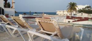 a group of chairs sitting on top of a boat at Casa Aura - King Suite with Kitchen and Balcony - 1st Floor in Isla Mujeres