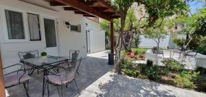 a patio with a table and chairs on it at Aeropis Villa, Chania in Chania