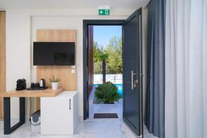 a room with a door leading to a pool at Hotel ASTERA in Skala Rachoniou