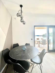 a dining room with a table and chairs at Villa Jadrana in Rab