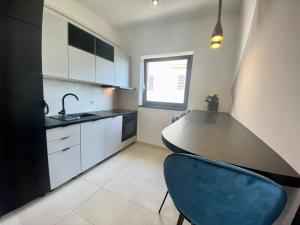 a kitchen with a blue chair next to a counter at Villa Jadrana in Rab