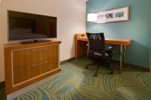 a room with a desk and a television and a chair at SpringHill Suites by Marriott Orlando Lake Buena Vista South in Kissimmee
