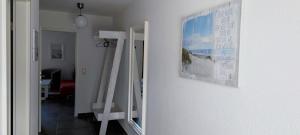 a mirror hanging on a wall with a picture on it at Sandsturm in Warnemünde