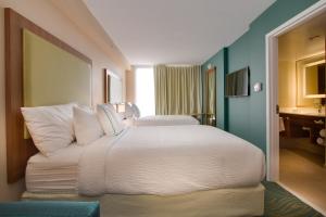 a bedroom with a large white bed in a room at SpringHill Suites by Marriott Orlando Lake Buena Vista South in Kissimmee
