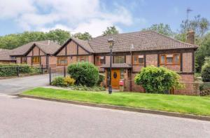 a large brick house with a driveway at Reads Lodge in Waterlooville