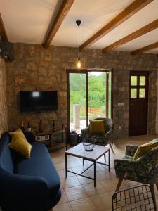 a living room with a blue couch and chairs at Guest House Mare in Bar