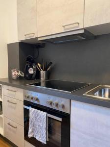 a kitchen with a stove top oven and a sink at Nette Wohnung, 8 km RB Ring in Fohnsdorf