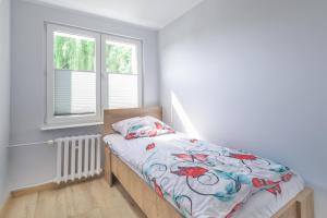 Postel nebo postele na pokoji v ubytování Redłowska Przystań - Plaża, Las, Miasto, Fiesta Apartments