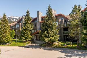 an apartment building with trees in front of it at Greyhawk 123 by Outpost Whistler in Whistler