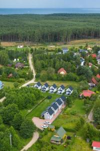 an aerial view of a small village with houses at Żurawie domki letniskowe in Kopalino