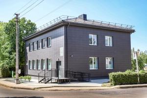 a large black building with a ramp in front of it at Akmenės svečių apartamentai Šypsena in Akmenė