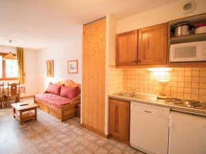 a kitchen and a living room with a couch at Appartement Aussois, 2 pièces, 4 personnes - FR-1-508-175 in Aussois